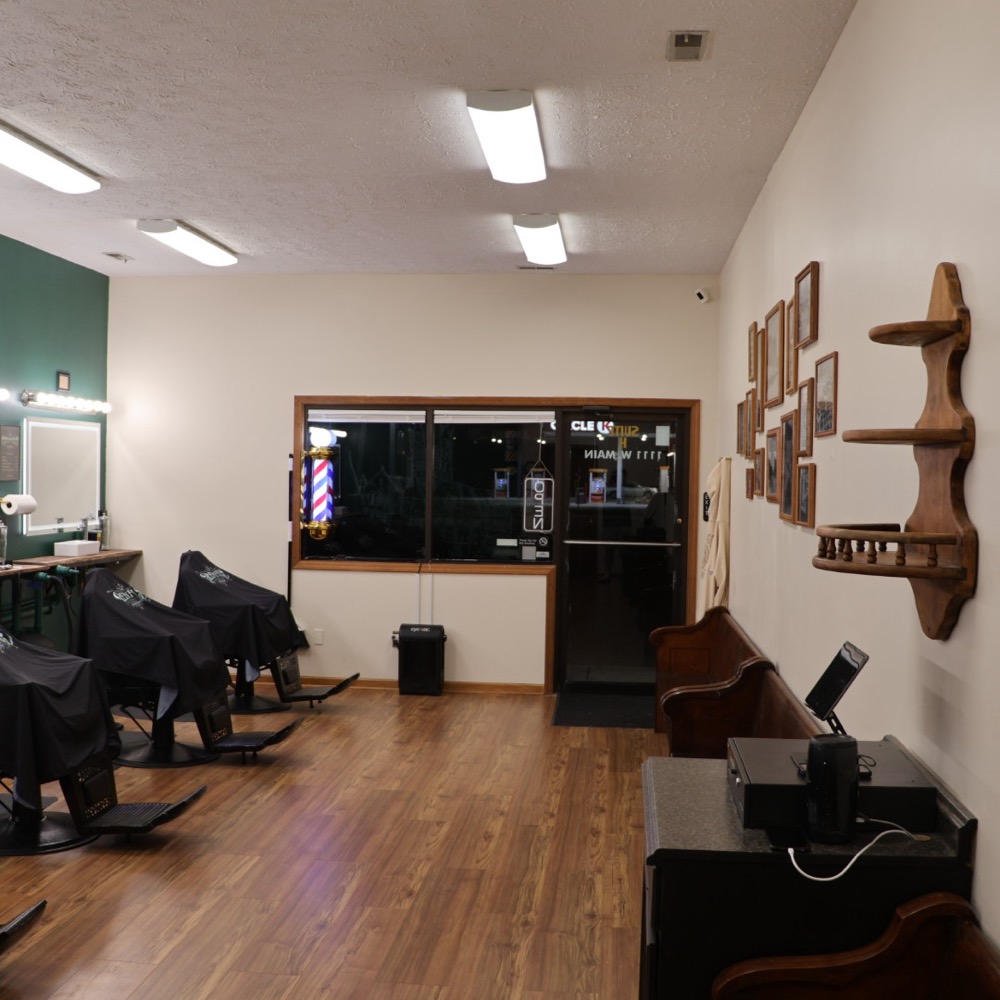 The front of the shop looking toward the door, with a wooden pew for waiting